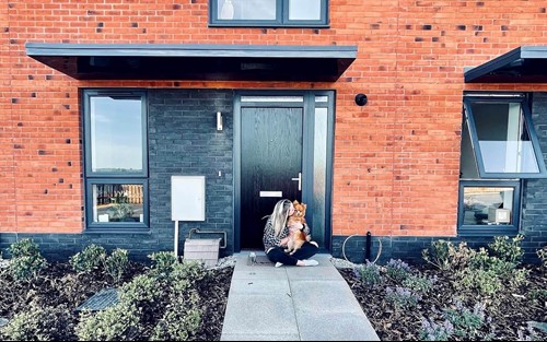 Emily and her dog Ralph outside their new home